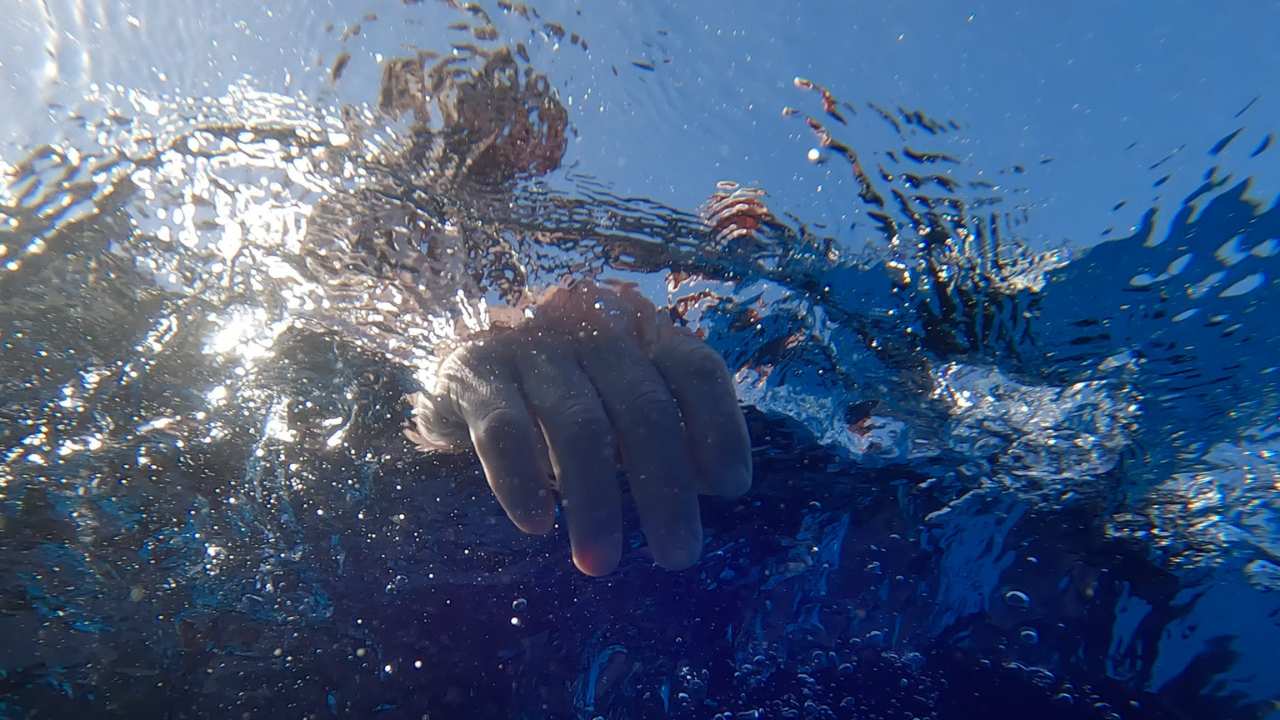 a person's hand under the water